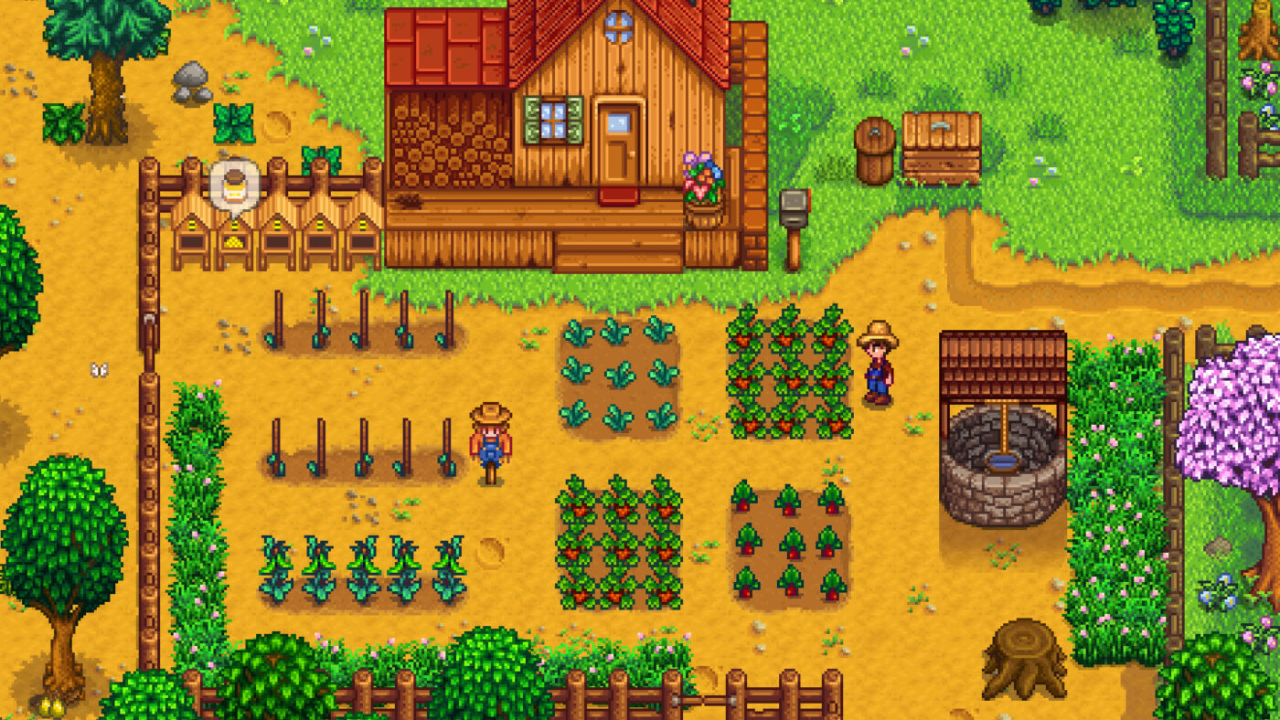 A farmer stands beside crops outside the farmhouse in Stardew Valley.